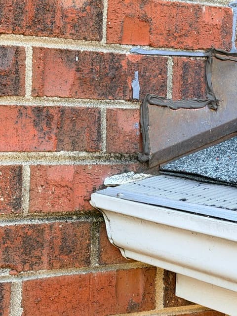 Roof flashing at brick wall